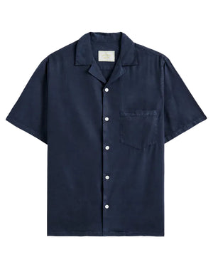 Navy short-sleeve shirt with button details on a beige background