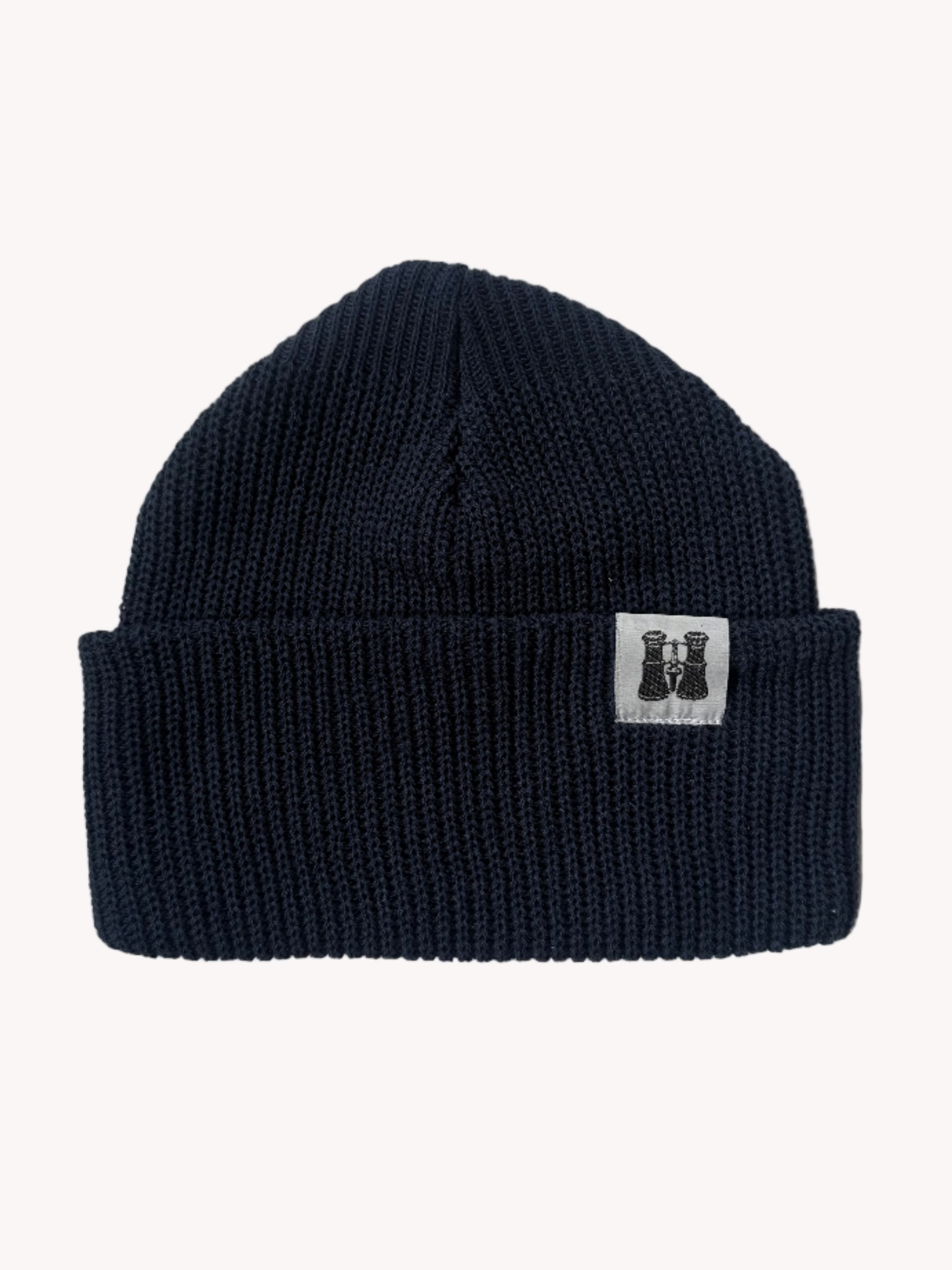 Navy blue knitted beanie with a brand logo on a white textured background