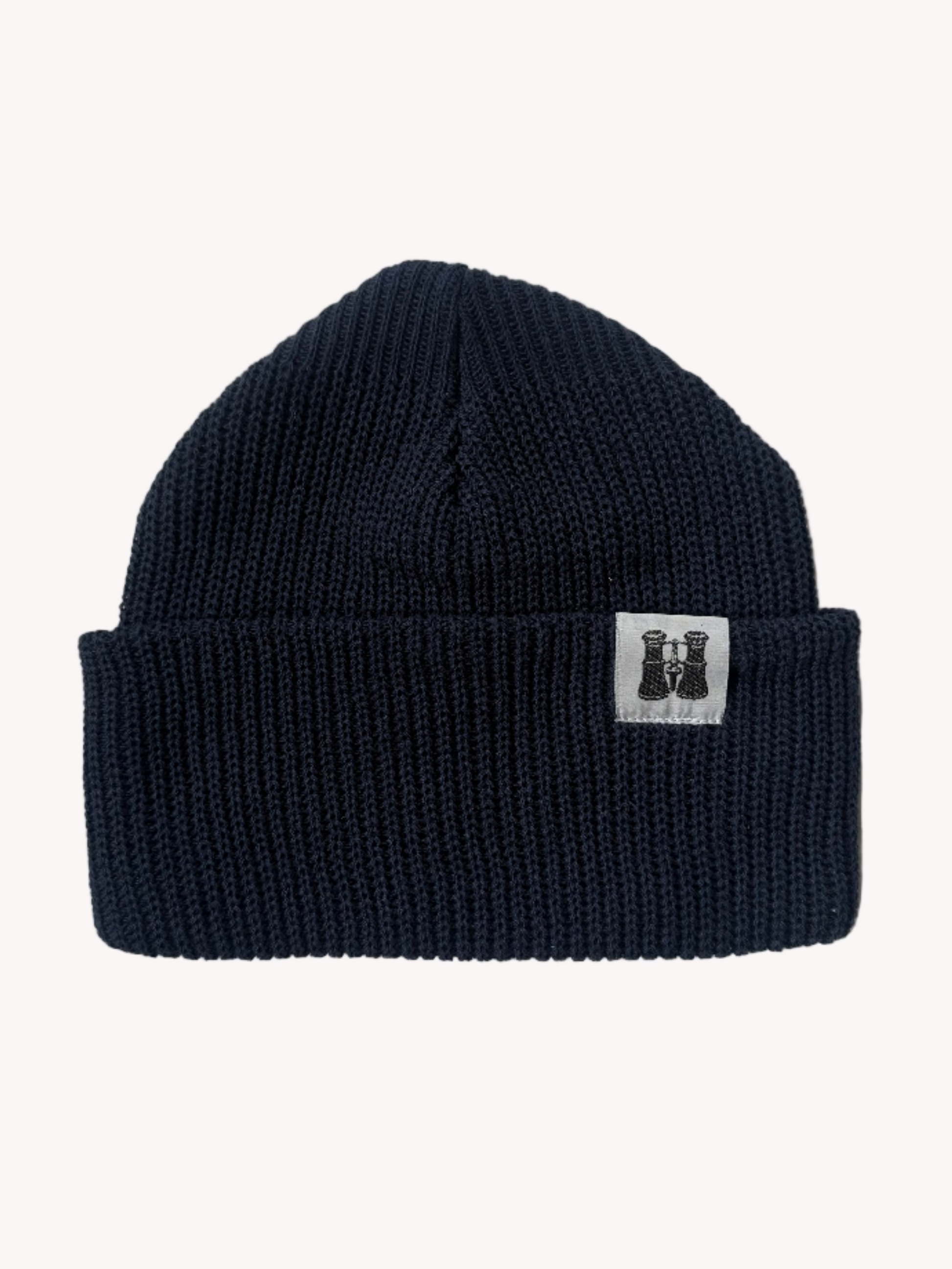 Navy blue knitted beanie with a brand logo on a white textured background