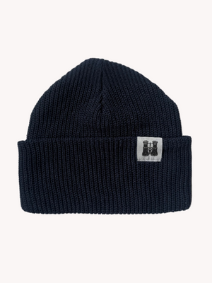 Navy blue knitted beanie with a brand logo on a white textured background