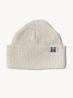 Off White specked knit beanie with a logo tag on a dark textured surface