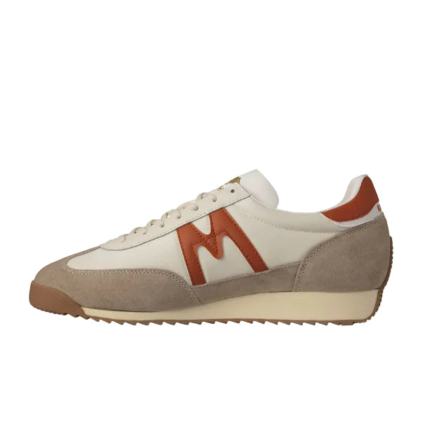 White and brown sneaker with a large 'M' logo on a white background