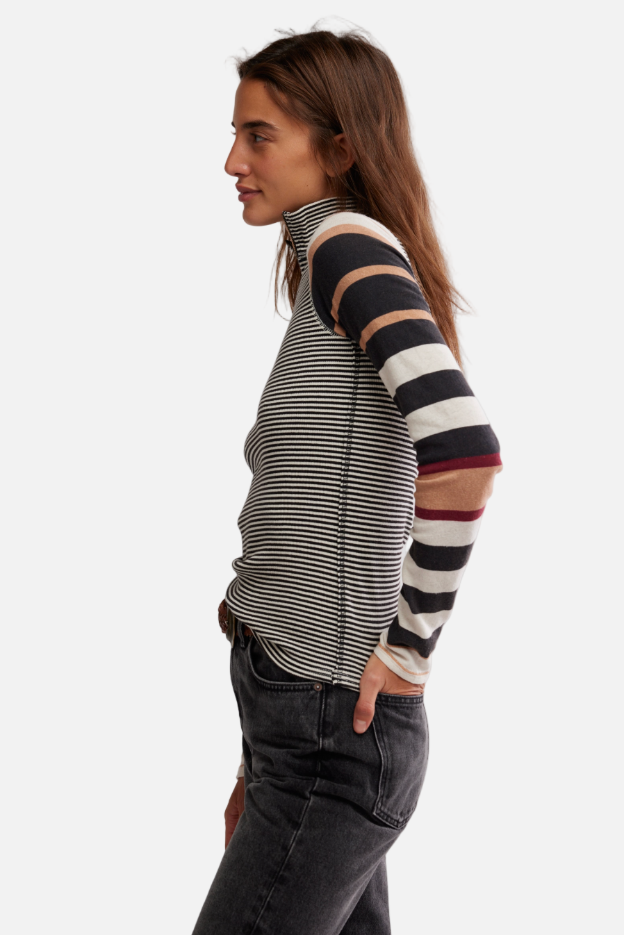 Woman wearing a striped long-sleeve top with cut-out design on a white background