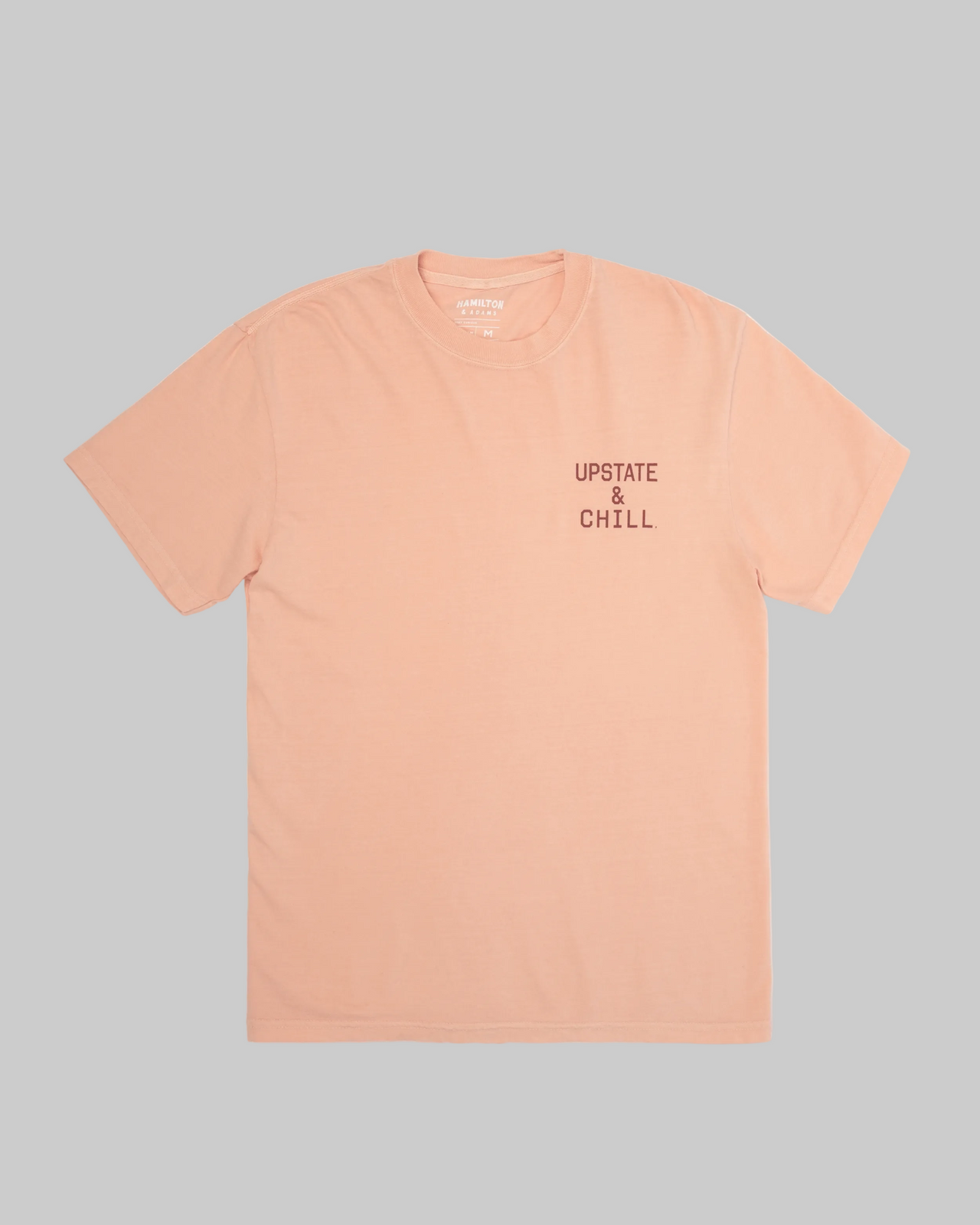 Peach t-shirt with 'Upstate & Chill' text on a white background