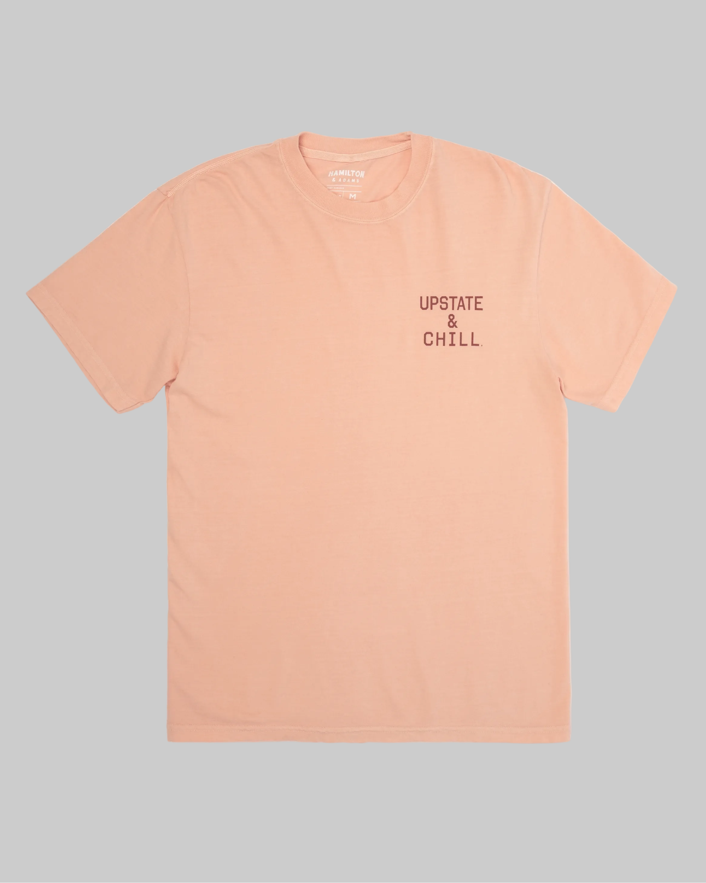 Peach t-shirt with 'Upstate & Chill' text on a white background
