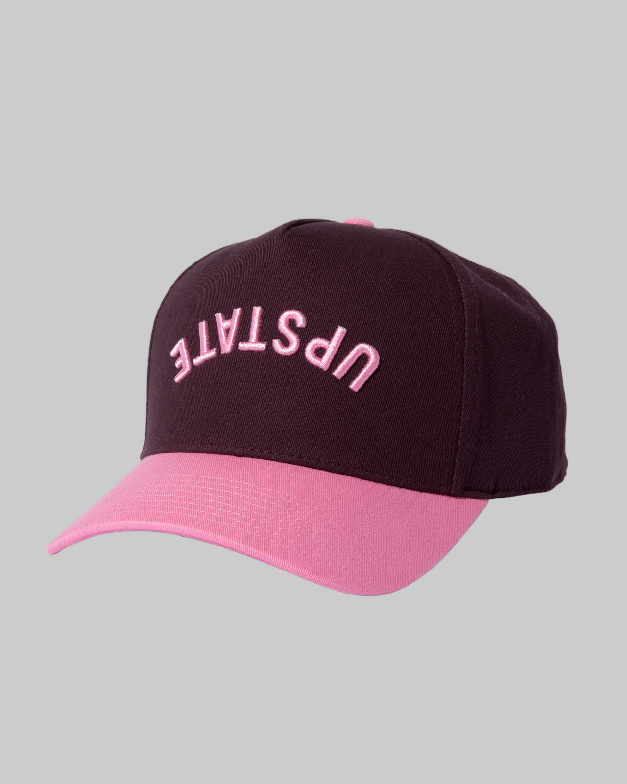 Black and pink cap with 'UPSTATE' text on a white background