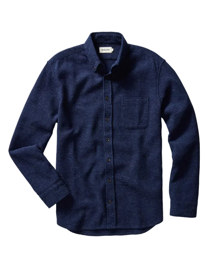 Blue button-up shirt on a white background