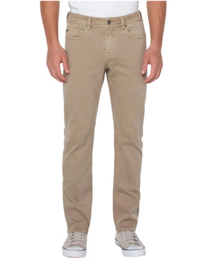Beige pants worn by a person on a white background